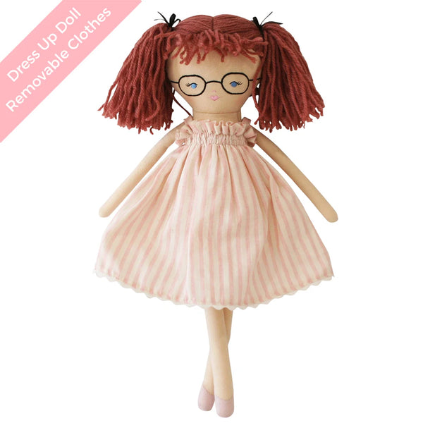 Dress up doll with red hair in pigtails wearing a pink stripe dress on a white background and text stating that the clothing is removable.