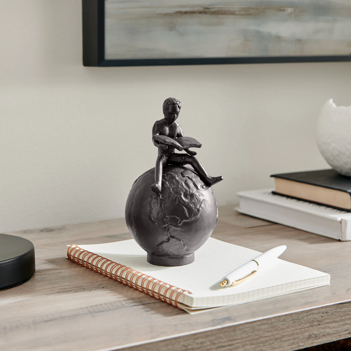 Brown Cast Iron Boy Reading on Globe Sculpture | Danya B.