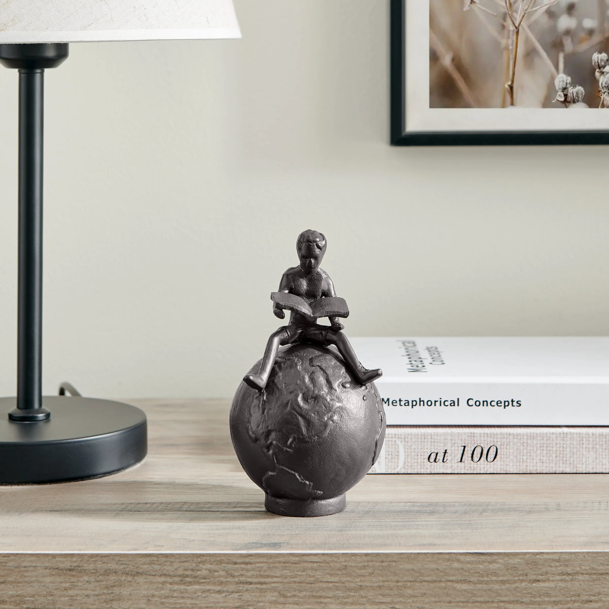 Brown Cast Iron Boy Reading on Globe Sculpture | Danya B.