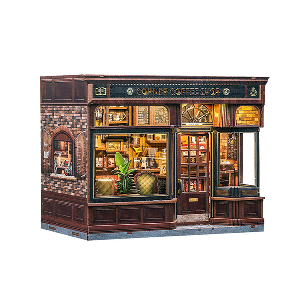 A miniature 3D puzzle model of a vintage corner coffee shop, featuring dark wood paneling, brick walls, and warm yellow glowing windows, shown on a plain white background.