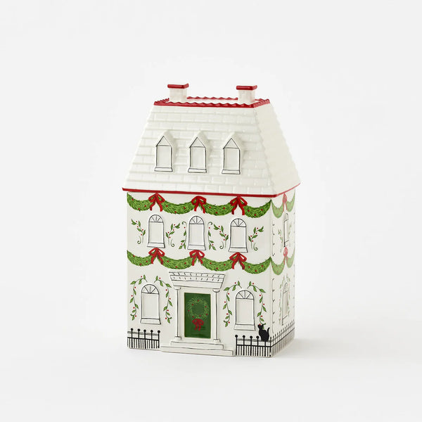 Decorative house-shaped box with Christmas-themed design on a white background