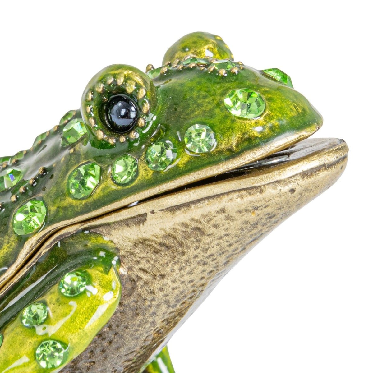 Decorative frog figurine with green gemstones on a white background
