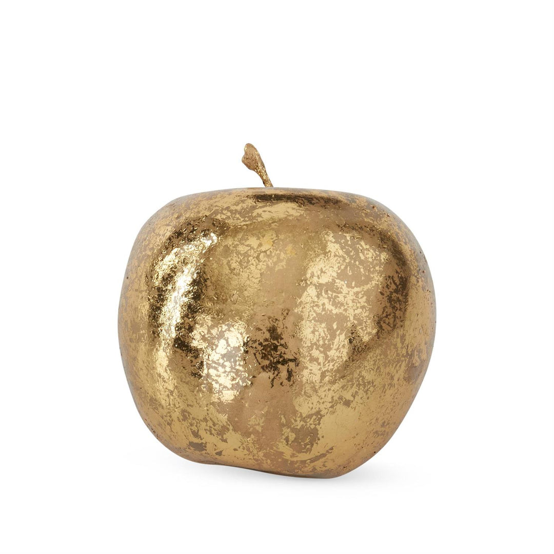 A decorative apple sculpture with a textured, metallic gold finish and a short stem, shown on a plain white background.