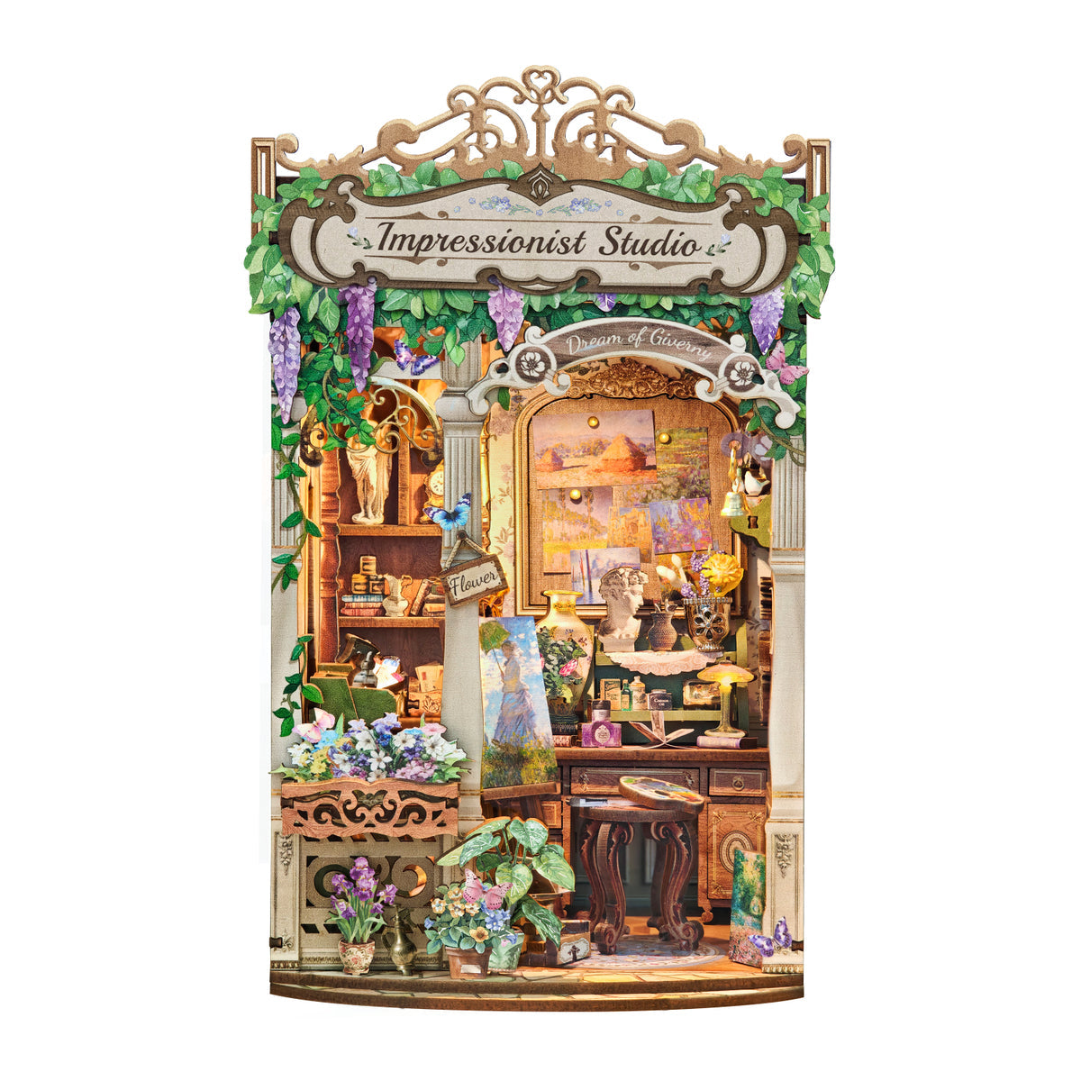A decorative miniature diy book nook set labeled 'Impressionist Studio' shown against a plain white background. The scene includes a detailed storefront facade with shelves, flowers, plants, lamps, and a central arched window area.