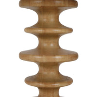 A close up of the main column of a carved accent table on a white background.