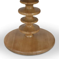 A close up of the base of a circular shaped accent table.