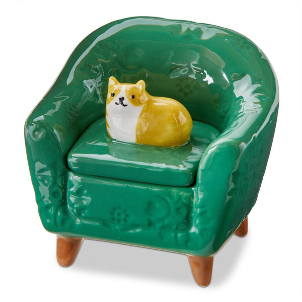 Green ceramic chair with an orange cat figurine on a white background