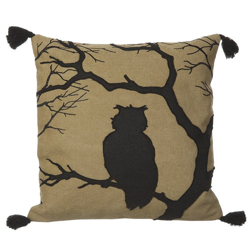 A square decorative throw pillow with a black owl silhouette and bare tree branches on a tan textured fabric background, finished with black tassels at the corners, shown on a plain white background.