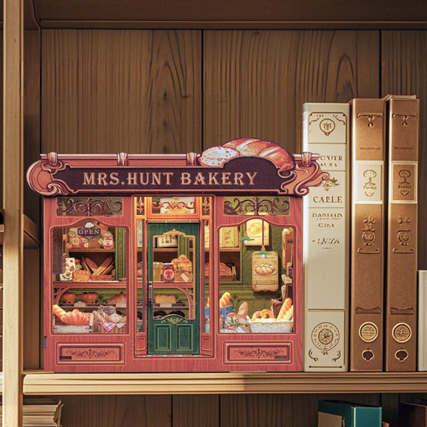 Model of a bakery shop with books on a wooden shelf