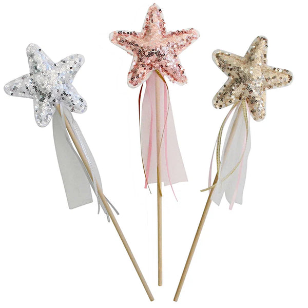 Three star-shaped sequin wand toppers on wooden sticks, shown against a plain white background. The left wand is silver, the center wand is rose gold, and the right wand is champagne gold, each with long sheer ribbons hanging below the stars.