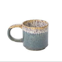 Speckled blue and brown ceramic mug on a white background