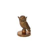 Bronze owl-shaped candle holder on a white background