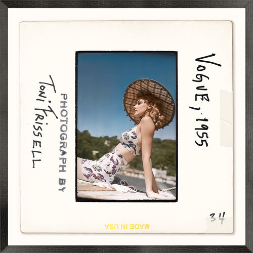Vintage photograph of a woman wearing a swimsuit and a straw hat with text indicating 'Toni Frissell, Photograph by' and 'Vogue 1955'.